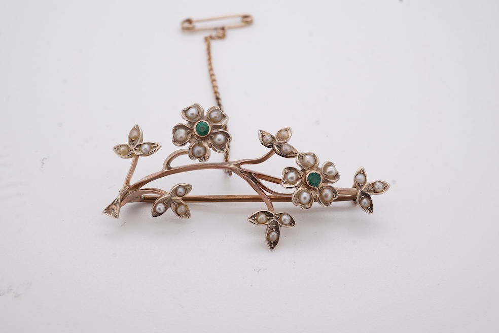 An early 20th century 9ct, seed pearl and emerald cluster set floral spray brooch, 45mm, gross weight 4.4 grams. Condition - poor to fair